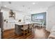 Open-concept kitchen with a large island, seating, and a dining area with expansive views at 3304 Canna Lily Pl, Clermont, FL 34711