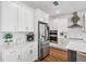 Spacious modern kitchen with stainless steel appliances and an island with barstool seating at 3304 Canna Lily Pl, Clermont, FL 34711
