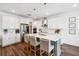Beautiful kitchen featuring stainless steel appliances, white cabinetry, and a center island with bar stools at 3304 Canna Lily Pl, Clermont, FL 34711