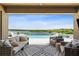 Inviting outdoor seating area with a view of the pool, spa, and serene lake at 3304 Canna Lily Pl, Clermont, FL 34711