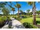Beautiful park with a picnic shelter, seating, and a sidewalk surrounded by palm trees and landscaping at 3304 Canna Lily Pl, Clermont, FL 34711