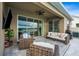 Relaxing covered patio with stylish outdoor seating, a ceiling fan, and a scenic view of the lake at 3304 Canna Lily Pl, Clermont, FL 34711
