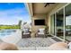 Inviting outdoor space with comfortable seating, TV, a view of the pool, and a glimpse of the lake beyond at 3304 Canna Lily Pl, Clermont, FL 34711