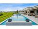 Luxury outdoor pool area featuring a lounge area, outdoor TV, and a serene view of the surrounding landscape at 3304 Canna Lily Pl, Clermont, FL 34711