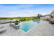 Gorgeous infinity pool and spa overlooking a picturesque lake with an adjacent golf course at 3304 Canna Lily Pl, Clermont, FL 34711