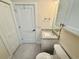This well-lit bathroom features a modern vanity, toilet, and white doors at 3607 Umbrella Tree Ln, Oxford, FL 34484