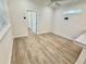 Bright bedroom showing the entrance to another bedroom and light-colored walls and flooring at 3607 Umbrella Tree Ln, Oxford, FL 34484