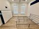 Bedroom with wood flooring and two windows providing lots of natural light at 3607 Umbrella Tree Ln, Oxford, FL 34484