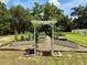 Community garden with raised garden beds and an arbor, offering a space for residents to grow their own food at 3607 Umbrella Tree Ln, Oxford, FL 34484