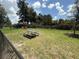 View of the fenced-in dog park with picnic tables for residents to enjoy at 3607 Umbrella Tree Ln, Oxford, FL 34484