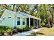 Charming home featuring a cozy screened porch and beautifully landscaped front yard with a brick pathway at 3607 Umbrella Tree Ln, Oxford, FL 34484