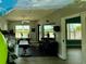 Community gym with workout equipment, ceiling fans, and large windows looking out to the pool area at 3607 Umbrella Tree Ln, Oxford, FL 34484