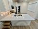 Modern kitchen with stone countertops, stainless steel appliances, and hardwood floors at 3607 Umbrella Tree Ln, Oxford, FL 34484