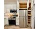 Modern kitchen featuring stainless steel appliances, ample cabinet space and granite countertops at 3607 Umbrella Tree Ln, Oxford, FL 34484