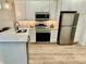 Well-equipped kitchen with stainless steel appliances, ample counter space, and modern cabinetry at 3607 Umbrella Tree Ln, Oxford, FL 34484