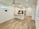 Open-concept living area with a kitchen island, stainless steel appliances, and modern lighting fixtures at 3607 Umbrella Tree Ln, Oxford, FL 34484