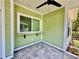 Corner of an outdoor screened porch featuring tiled flooring, a ceiling fan, and views of the surrounding landscape at 3607 Umbrella Tree Ln, Oxford, FL 34484