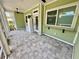 Spacious outdoor screened porch featuring tiled flooring, ceiling fans, and ample natural light at 3607 Umbrella Tree Ln, Oxford, FL 34484