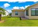 Backyard with a well-maintained lawn, offering a peaceful outdoor space at 362 Arbella Loop, The Villages, FL 32162