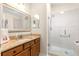 A bathroom with a glass shower and a granite countertop at 362 Arbella Loop, The Villages, FL 32162