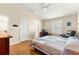 A bedroom with a ceiling fan and light wood floors at 362 Arbella Loop, The Villages, FL 32162