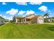 Charming home featuring a well-kept lawn, mature trees, and an attached garage at 362 Arbella Loop, The Villages, FL 32162