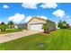 Home with a manicured lawn and two-car garage offers ample parking and curb appeal at 362 Arbella Loop, The Villages, FL 32162