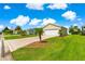 Attractive home featuring a well-maintained lawn, palm trees, and a two-car garage at 362 Arbella Loop, The Villages, FL 32162