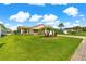 Beautifully landscaped front lawn with lush green grass and well-placed palm trees for tropical curb appeal at 362 Arbella Loop, The Villages, FL 32162