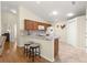 A kitchen with granite countertops, stainless steel appliances, and a breakfast bar at 362 Arbella Loop, The Villages, FL 32162