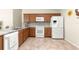 Modern kitchen featuring wood cabinets, granite countertops, and stainless steel appliances at 362 Arbella Loop, The Villages, FL 32162