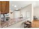 A kitchen with granite countertops and a breakfast bar at 362 Arbella Loop, The Villages, FL 32162
