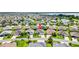 An aerial view showcases the home in a beautiful neighborhood setting near a peaceful lake at 3759 Orient Ave, The Villages, FL 32163
