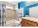 Bathroom with modern shower/tub with blue accent wall at 3759 Orient Ave, The Villages, FL 32163