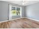 Bedroom with a ceiling fan, wood floors, and view of front yard at 3759 Orient Ave, The Villages, FL 32163