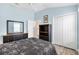 This charming bedroom features a comfortable bed and ample storage in its dresser and closet at 3759 Orient Ave, The Villages, FL 32163
