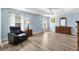 Spacious bedroom with a tray ceiling, a ceiling fan, wood floors and abundant natural light at 3759 Orient Ave, The Villages, FL 32163