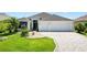 Charming single-story home with a well-manicured lawn and a spacious two-car garage at 3759 Orient Ave, The Villages, FL 32163