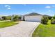 A home with a wide driveway, a beautiful lawn, and mature landscaping at 3759 Orient Ave, The Villages, FL 32163