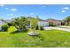 Well-maintained front yard featuring lush green grass, trees, and landscaping elements at 3759 Orient Ave, The Villages, FL 32163