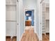 Hallway between two walk-in closets with a view to en suite bathroom at 3759 Orient Ave, The Villages, FL 32163