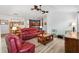 Open-concept living area with comfortable seating, modern lighting, and open kitchen access at 3759 Orient Ave, The Villages, FL 32163