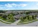 Wide aerial view of the home, with landscaped front yard and circular driveway at 4018 Chandler Estates Dr, Apopka, FL 32712