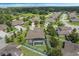 Backyard with screen-enclosed pool, privacy hedges, a manicured lawn, and lush tropical landscaping at 4018 Chandler Estates Dr, Apopka, FL 32712