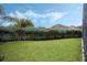 Manicured backyard with lush lawn, mature trees, and privacy fence at 4018 Chandler Estates Dr, Apopka, FL 32712