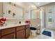 Bright bathroom featuring a spacious vanity, large mirror, and glass-enclosed shower at 4018 Chandler Estates Dr, Apopka, FL 32712
