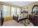 Cozy bedroom with large windows, yellow curtains, and elegant dark wood furniture at 4018 Chandler Estates Dr, Apopka, FL 32712