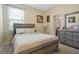 Calming bedroom with a serene color palette, comfortable bed, and dresser at 4018 Chandler Estates Dr, Apopka, FL 32712