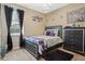 Stylish bedroom with modern furniture, purple accents, and a cozy rug at 4018 Chandler Estates Dr, Apopka, FL 32712