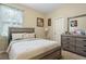 Calming bedroom with a serene color palette, comfortable bed, and dresser at 4018 Chandler Estates Dr, Apopka, FL 32712